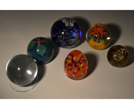Paperweights - clear glass ball on stand; seascape weight with dolphins; opaque green and blue weight with central flower mot