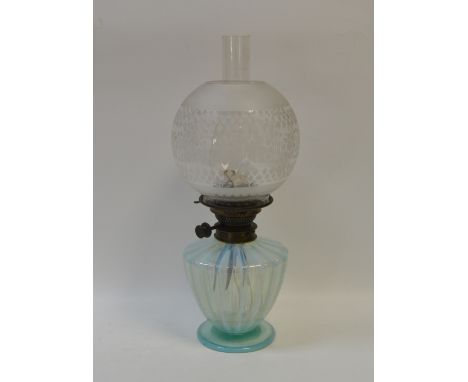 A Victorian vaseline and blue flash oil lamp, globular clear glass and frosted shade, shouldered ovoid fluted base, circular 