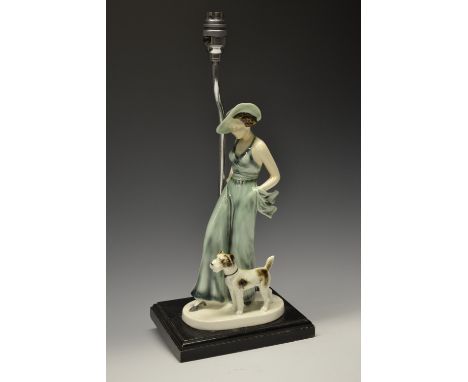 An Art Deco chrome table lamp, the plinth base mounted with an earthenware figure, modelled as a Lady of Fashion in a trouser