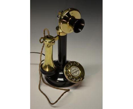 A 1920s brass and cast metal dial-up candlestick telephone, daffodil mouth piece, by UT, model number C 108C, the earpiece re