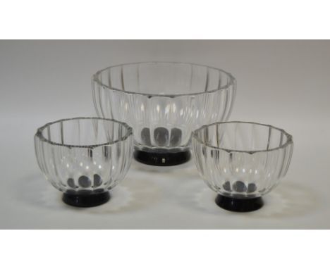 A large Orrefors fluted bowl, black base, 21cm diam, LA355;  two similar smaller, 12cm diam, LA355 (3)