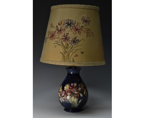 A Moorcroft Spring Flowers pattern baluster table lamp, tube lined with colourful flowers on a cobalt blue ground, 20cm high,