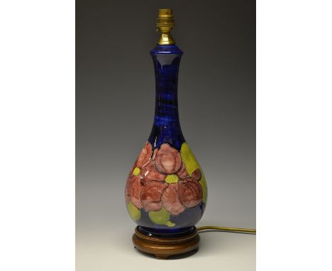 A Moorcroft Anemone pattern baluster lamp base, tube lined with large flowerheads in tones of red, green foliage, on a cobalt