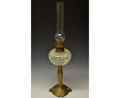 A French Art Nouveau parcel gilt oil lamp, the pedestal base cast with bluebells and swirling fluid forms, ovoid vaseline gla