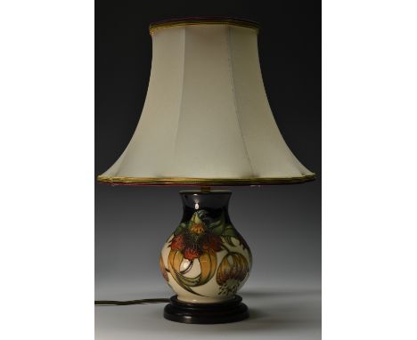 A contemporary Moorcroft Anna Lily pattern baluster table lamp, tube lined with large flowerheads and leaves in shades of gre