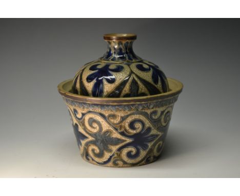A Doulton Lambeth tapering cylindrical planter and cover, incised with large stylised leaves and strapwork in tones of blue o
