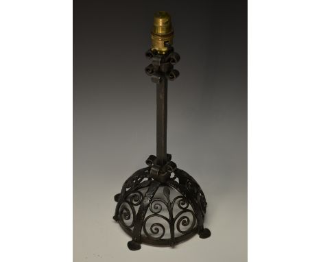 An Arts and Crafts wrought iron table lamp, the domed base worked with scrolls, 38.5cm high, early 20th century