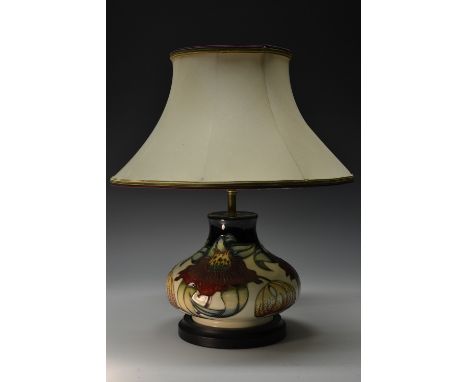 A contemporary Moorcroft Anna Lily pattern compressed ovoid table lamp, tube lined with large flowerheads and leaves in shade