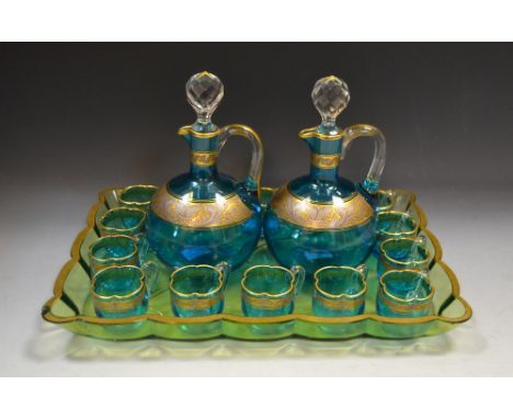 A Bohemian turquoise and clear glass liqueur set, comprising two globular flask, with prismatic stoppers, clear loop handles,