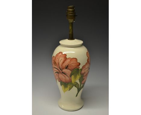 A contemporary Moorcroft Hibiscus pattern ovoid table lamp, tubelined and decorated in autumnal tones on a cream ground, 39cm