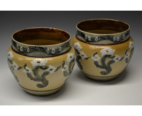 A pair of Doulton Lambeth stoneware jardinieres, designed by Elizabeth Gilman, applied with white flowerheads and leafy stems