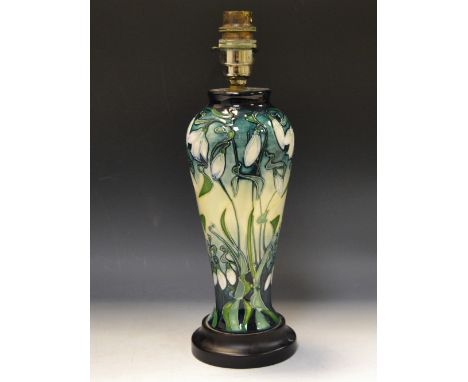 A contemporary Moorcroft Snowdrops pattern slender ovoid table lamp, tube lined with flowerheads and foliage, in tones of gre