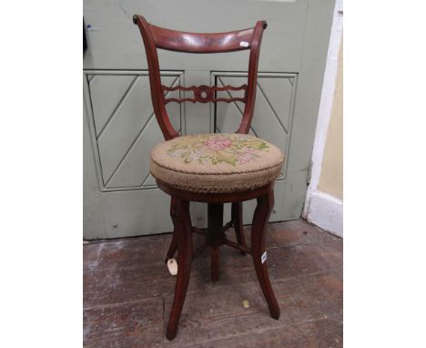 A 19th century music stool/chair in satin wood with shaped and scrolled bar back, pierced splat, circular revolving floral ta