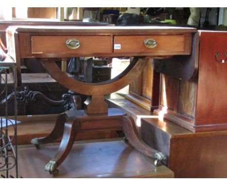 A regency mahogany sofa table the top cross banded with an ebony string inlay fitted with two frieze drawers raised on a hors