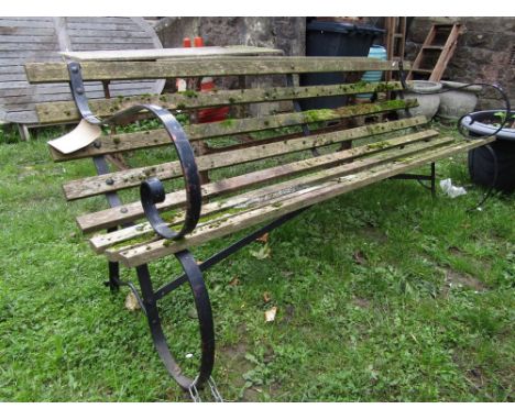 A sprung steel framed three seat garden bench with open scrolled arms and weathered timber open slatted and back, 193cm long 