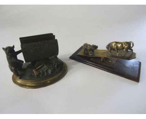 A late 19th century desk top paper clip, the brass top monitor with a fighting bull and bear together with a 19th century cas