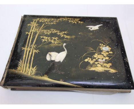 A 19th century album containing large format photographs with coloured finish depicting various aspects of Japanese life and 