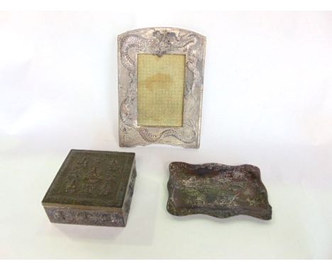 A Chinese pewter photograph frame with dragon detail; together with a dish and trinket box of Burmese origin