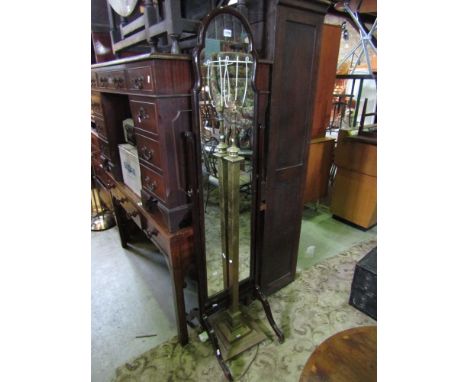 A mahogany cheval glass of narrow proportions raised on shaped supports, together with a brass telescopic lamp standard raise