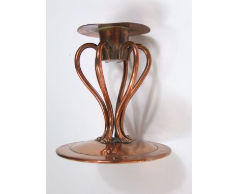 Am Arts & Crafts hand wrought copper candlestick raised on six shaped supports on a domed base, 12 cm