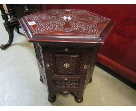 A small late 19th century octagonal occasional table in the Moorish style with mother of pearl chip detail