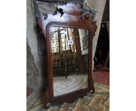 A small Chippendale revival wall mirror with carved fretwork outline and moulded detail
