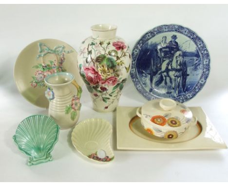 A collection of Clarice Cliff wares including a circular tureen and cover in the Rhodanthe pattern in tones of orange, gold a