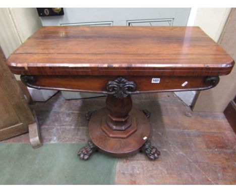 A Victorian rosewood veneerer fold over top lined card table of rectangular form, with rounded front corners and circular bai