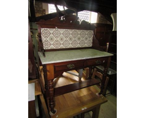 A Victorian mahogany wash stand with marble top and raised ceramic splash back on turned supports