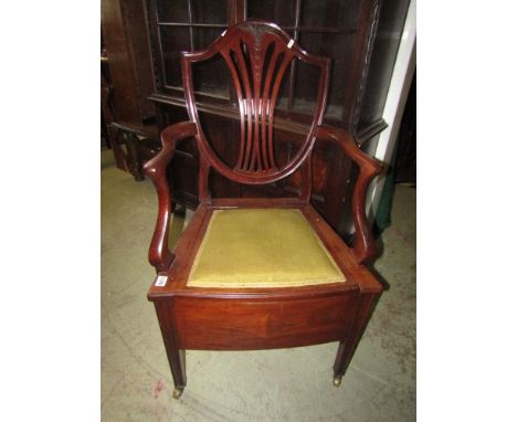 An inlaid Edwardian mahogany commode elbow chair in the Georgian hepplewhite style with inlaid detail