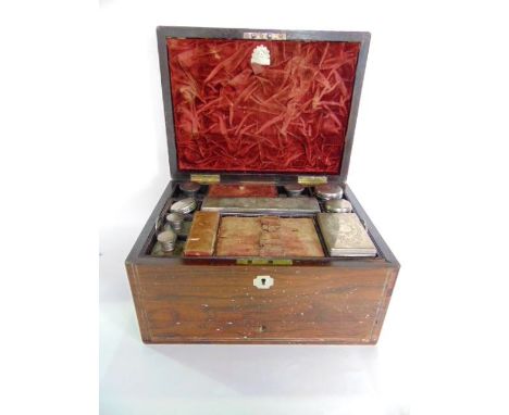 A 19th century rosewood and pearl inlaid dressing chest, the hinged lid enclosing many white metal topped glass compartments,