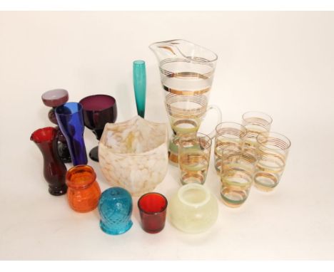 A collection of various art glass to include a lemonade set, amethyst glass goblet, mottled glass shade, etc