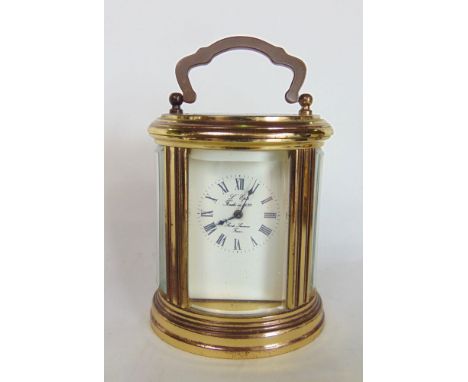 Miniature oval brass carriage clock the enamelled dial inscribed "L'Epee", 8cm high