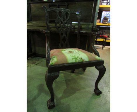 A Chippendale style elbow chair with carved and pierced Gothic tracery splat and other carved detail, upholstered seat and cl
