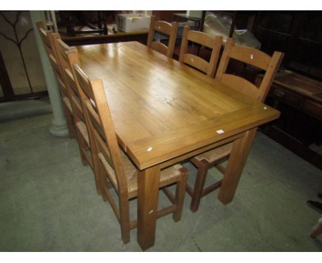 An oak refectory table, the heavy planked top with cleated ends raised on square cut supports, together with a set of 6 ladde