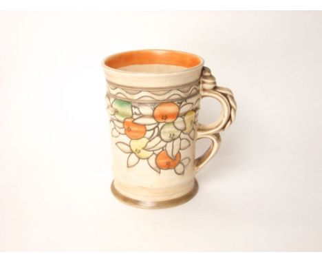 A Crown Ducal tankard designed by Frederic Rhead with a double looped handle and painted fruit design with printed marks to b