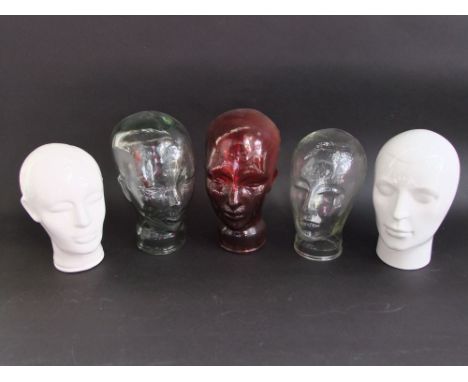Three glass heads to include one in red glass together with two ceramic examples (5)