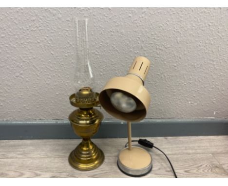 Antique brass based oil lamp with glass chimney together with a vintage metal desk lamp