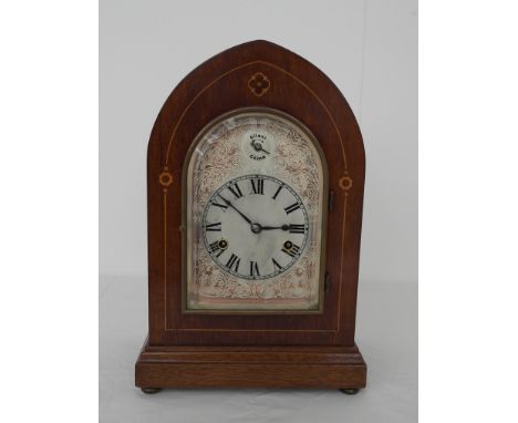 An edwardian mahogany inlaid mantle clock
