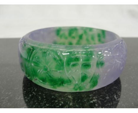 A Lilac and Green Jadeite Bangle with Carved Ruyi Shapes
