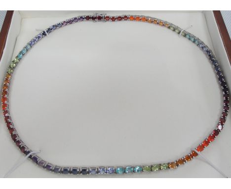 A Silver and Multi Stone Necklace:
With claw set semi-precious stones in articulated link silver necklace, Tanzanite, Amethys