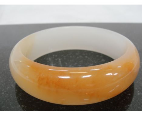An Orange and White Jadeite Bangle