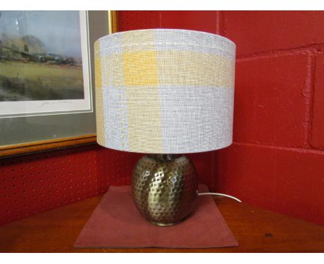 A hammered brass effect bulbous table lamp, with yellow and grey shade, 38cm total height