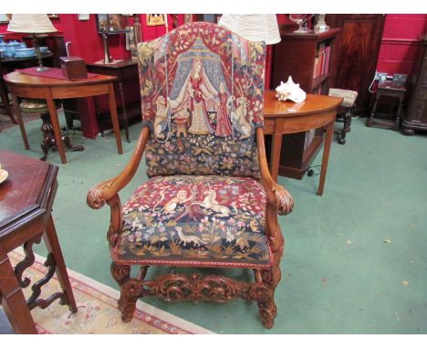 An 18th Century style carved walnut open armchair with acanthus leaf scroll arms and tapestry upholstery