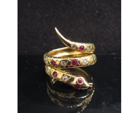 A high carat gold snake ring set with ruby and diamonds in rubover setting, 10.7g