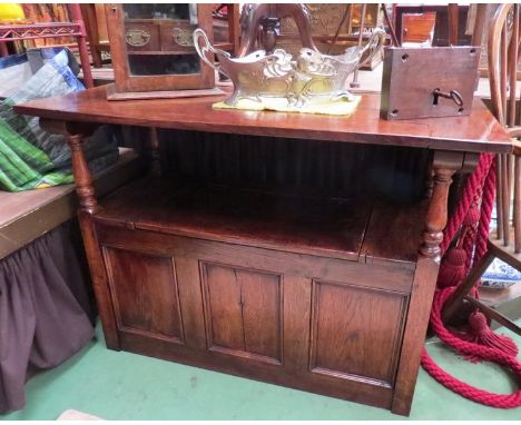 An 18th Century revival oak monk's bench the drop down table top over a hinged seat box seat settle with turned supports. 105