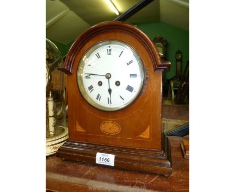 A Mantle clock with Roman numerals, marquetry detailing to the front. Key and pendulum present, (some damage to face). 9 1/2"
