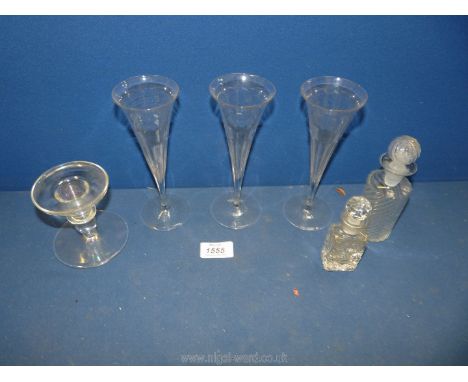 Three slim antique champagne glasses, cut glass scent bottle, early moulded rose water bottle and a dumpy glass candlestick w