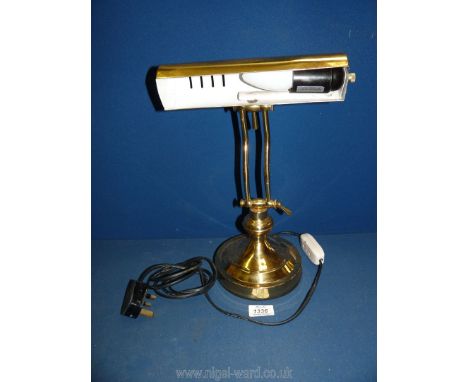 A brass finish banker's lamp.