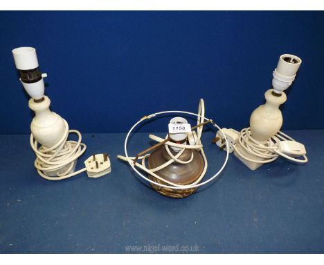 A brown pottery lamp base with a pair of cream marble lamp bases.